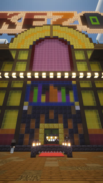 Low camera pushes up a Minecraft street toward a giant jukebox building that serves as a nightclub at server spawn.