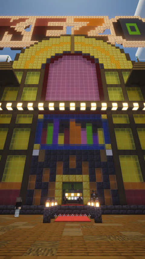 Low camera pushes up a Minecraft street toward a giant jukebox building that serves as a nightclub at server spawn.